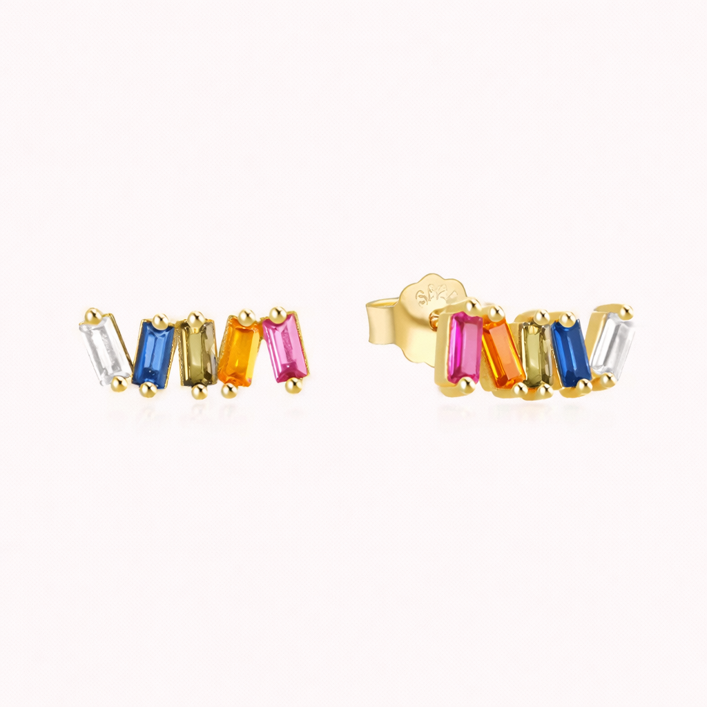 Solara Earrings line up five multicolor baguette stones in a gold curved row, from clear to blue, olive, orange, and pink.