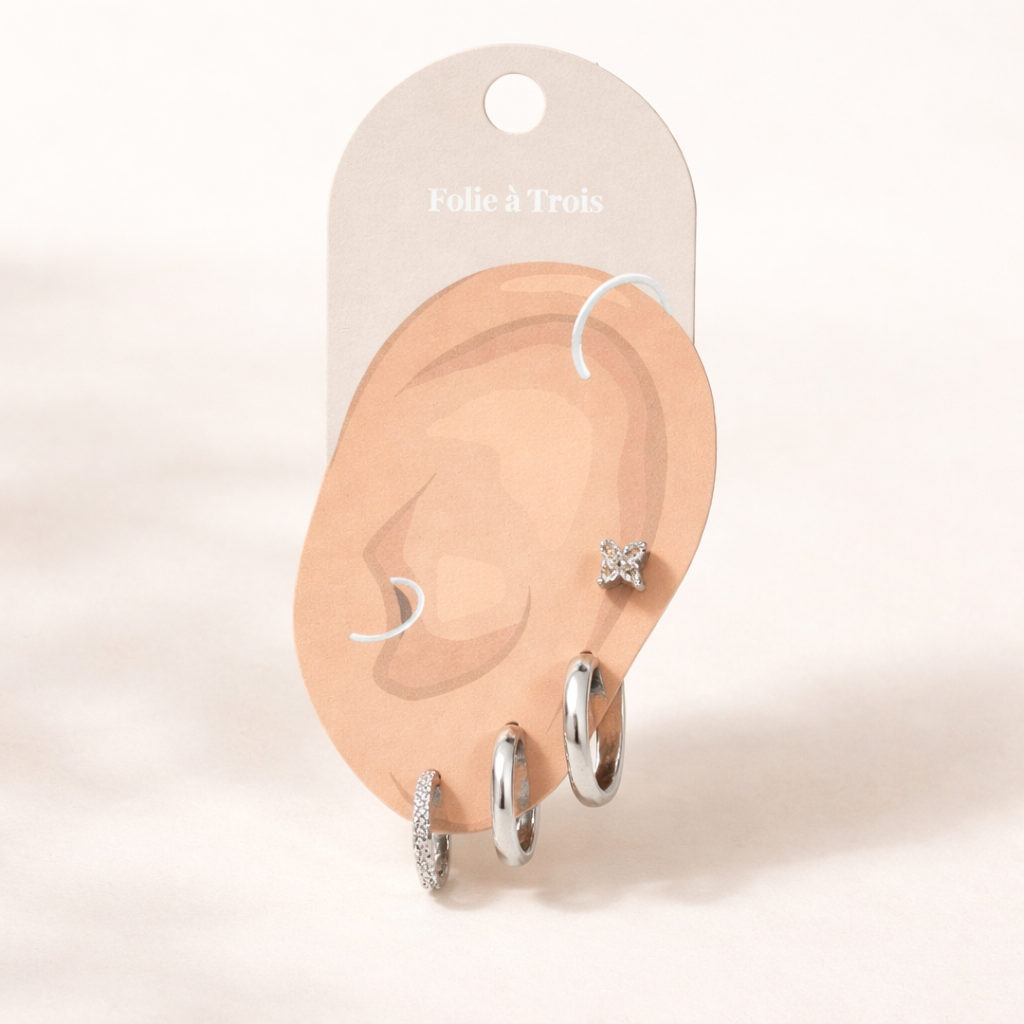 Sophia Set displayed on a Folie a Trois ear-shaped card in silver tone, arranging the clover stud and hoop trio for styling.
