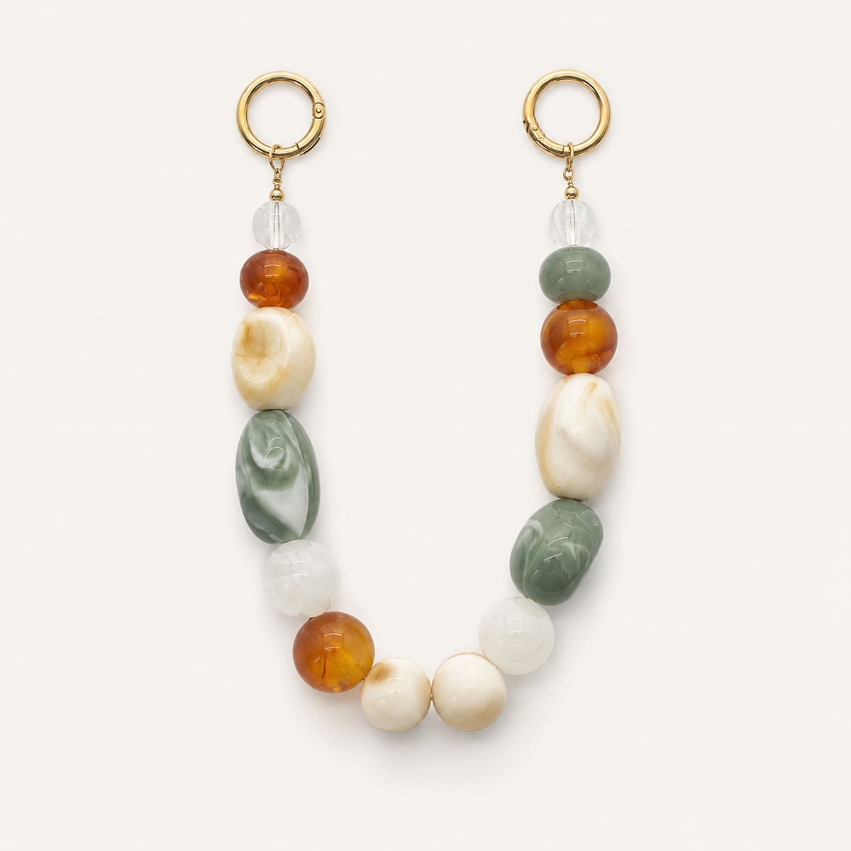 Chunky beaded phone chain with amber, sage green, and cream marbled beads and gold hoop clasps — Folie à Trois Talia wholesale phone accessory