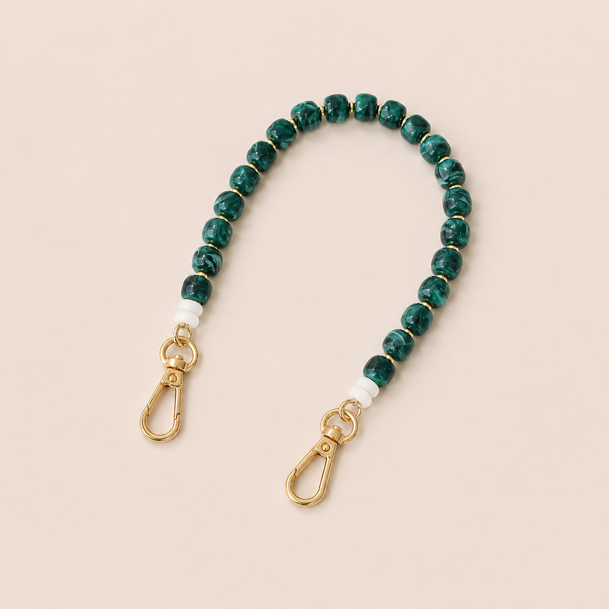 Green marbled bead phone chain with white spacers and gold clasps on cream — Folie à Trois Teagan wholesale phone chain