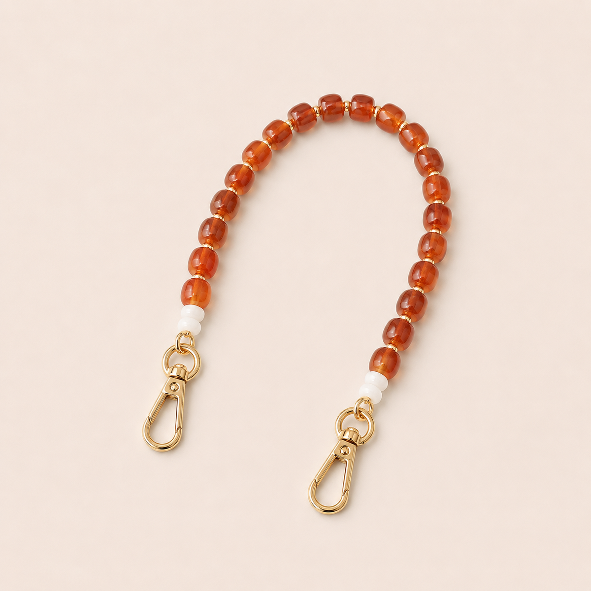 Amber bead phone chain with white spacers and gold clasps on cream — Folie à Trois Teagan wholesale phone chain