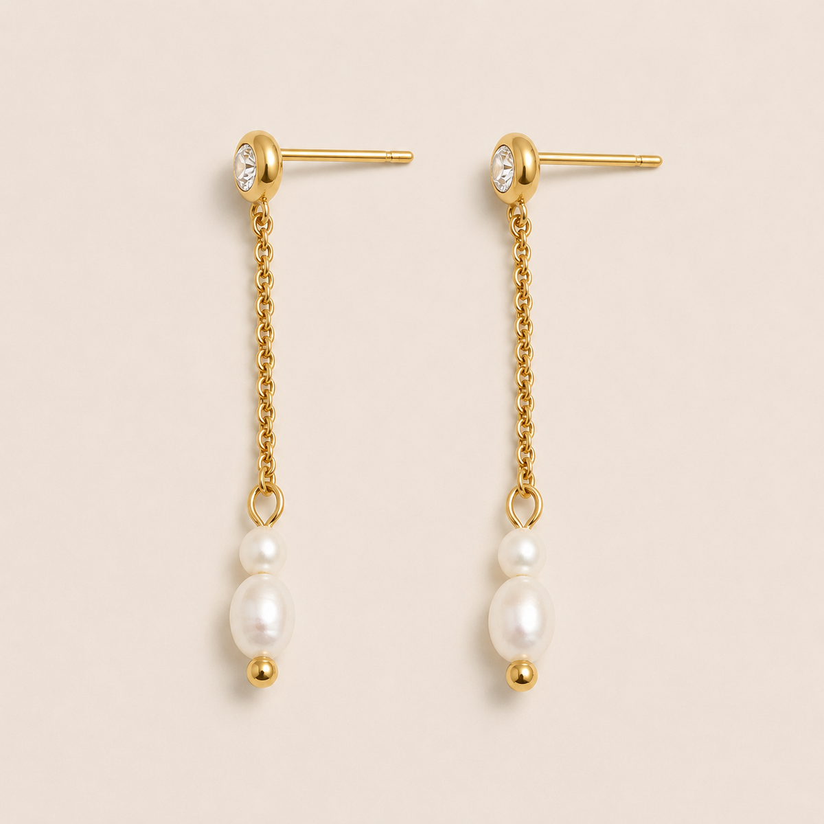 Gold drop earrings with a zirconia stud, fine chain and two graduated pearls on a cream backdrop — Folie à Trois Whisper EARRINGS