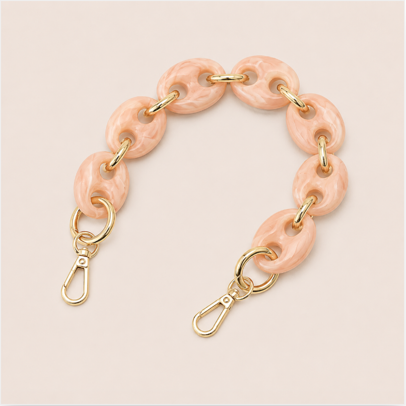 Folie à Trois Wilder short wholesale phone chain in blush pink marbled puffed acetate links with gold connectors, laid flat on a cream background.