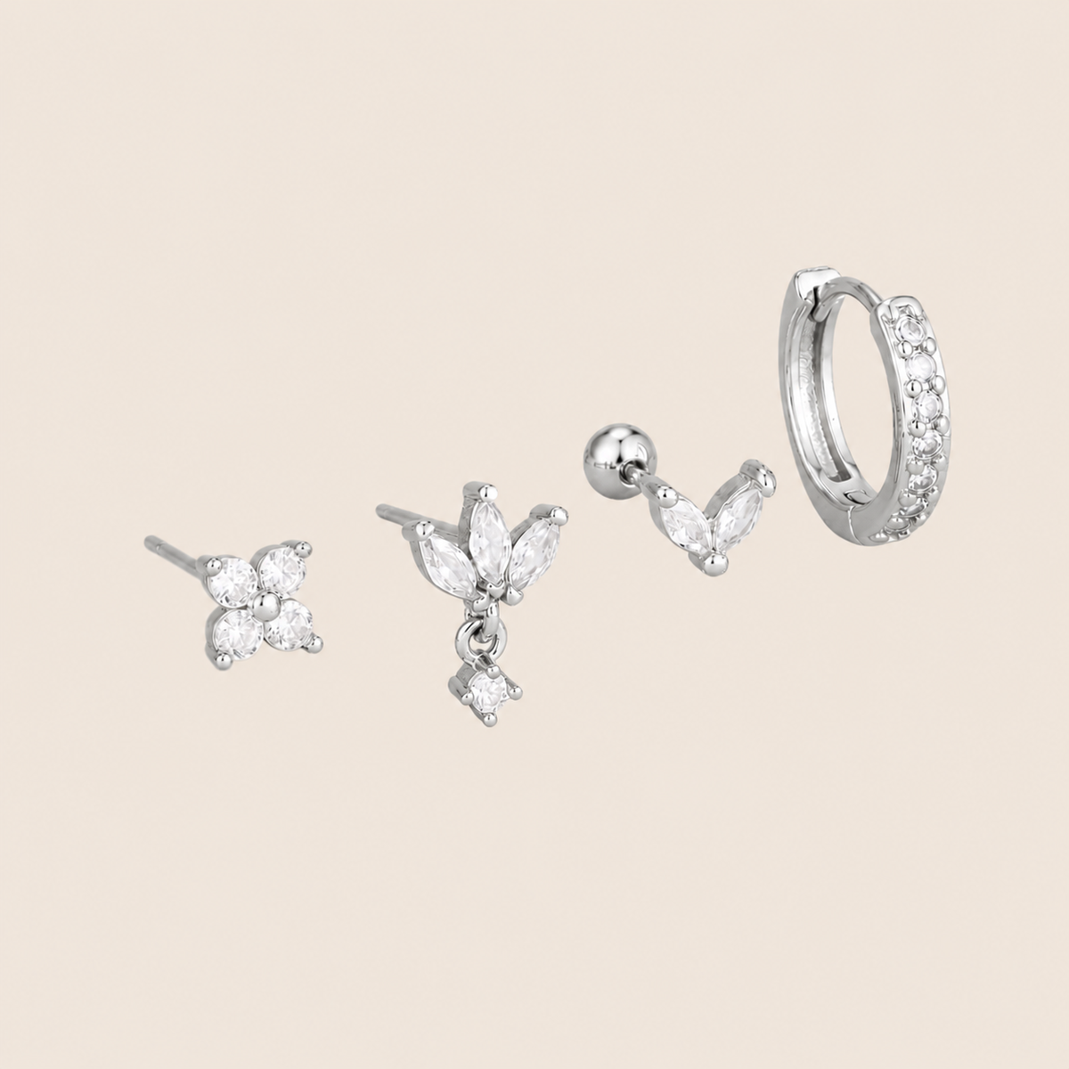 Four-piece Willow SET silver earrings: a four-stone flower stud, a marquise drop stud, a small marquise ear-climber, and a pave hoop.