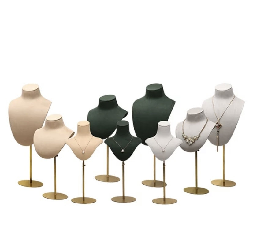 Full set of Mannequin Velvet DISPLAY busts in beige, pink, green and white velvet arranged by height on gold stands.