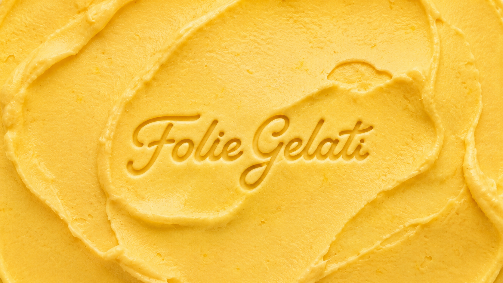 The words "Folie Gelati" written into swirled yellow gelato texture.