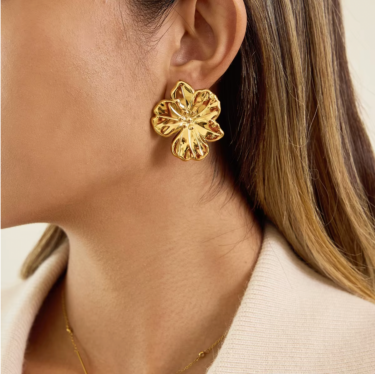 Gold-plated flower-shaped stud earrings with sculpted petals and a polished finish
