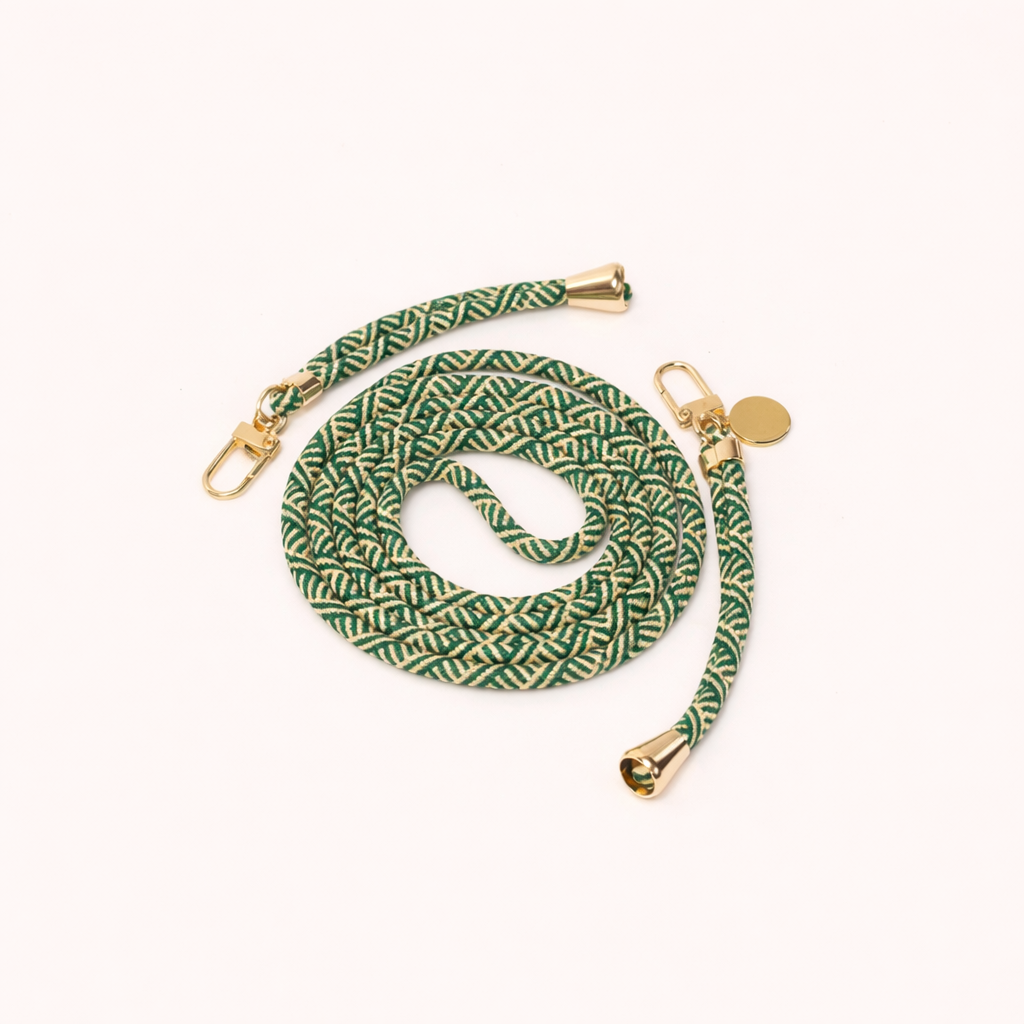 Green and cream patterned Aesthetic Colorful PHONE CORD coiled with gold hardware and a charm, shown as a flat lay.