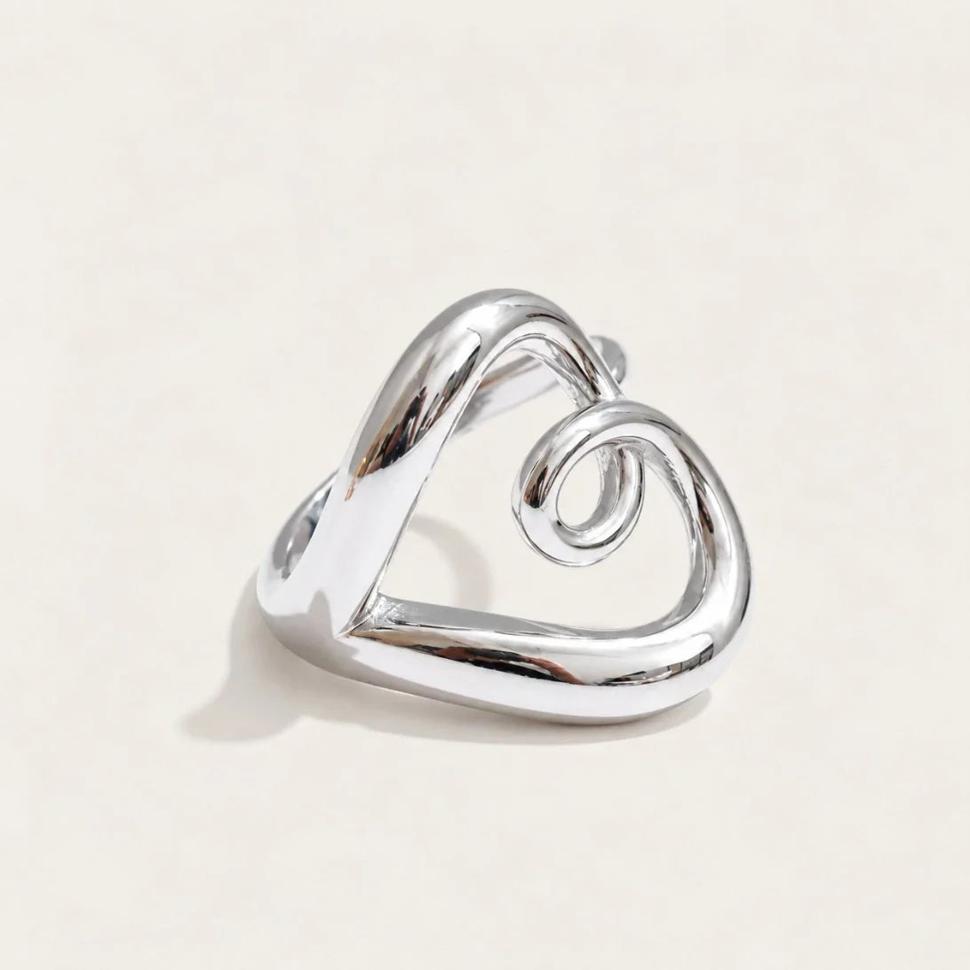 Silver-tone Amore RING: a rounded open band that twists and curls into a heart outline — Folie à Trois