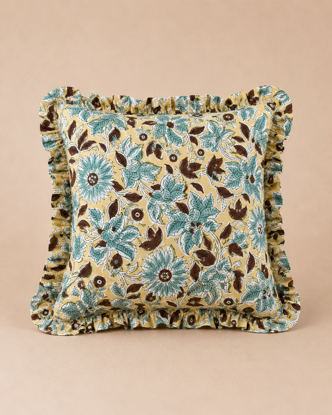 Aqua Blossom Square cushion in mustard yellow with a teal and brown block-print floral pattern, finished with a matching ruffled trim.