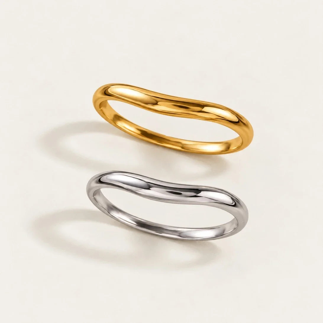 Gold and silver-tone Arco BRACELETS, slim bangles with a gentle curved arch, seen from above — Folie à Trois