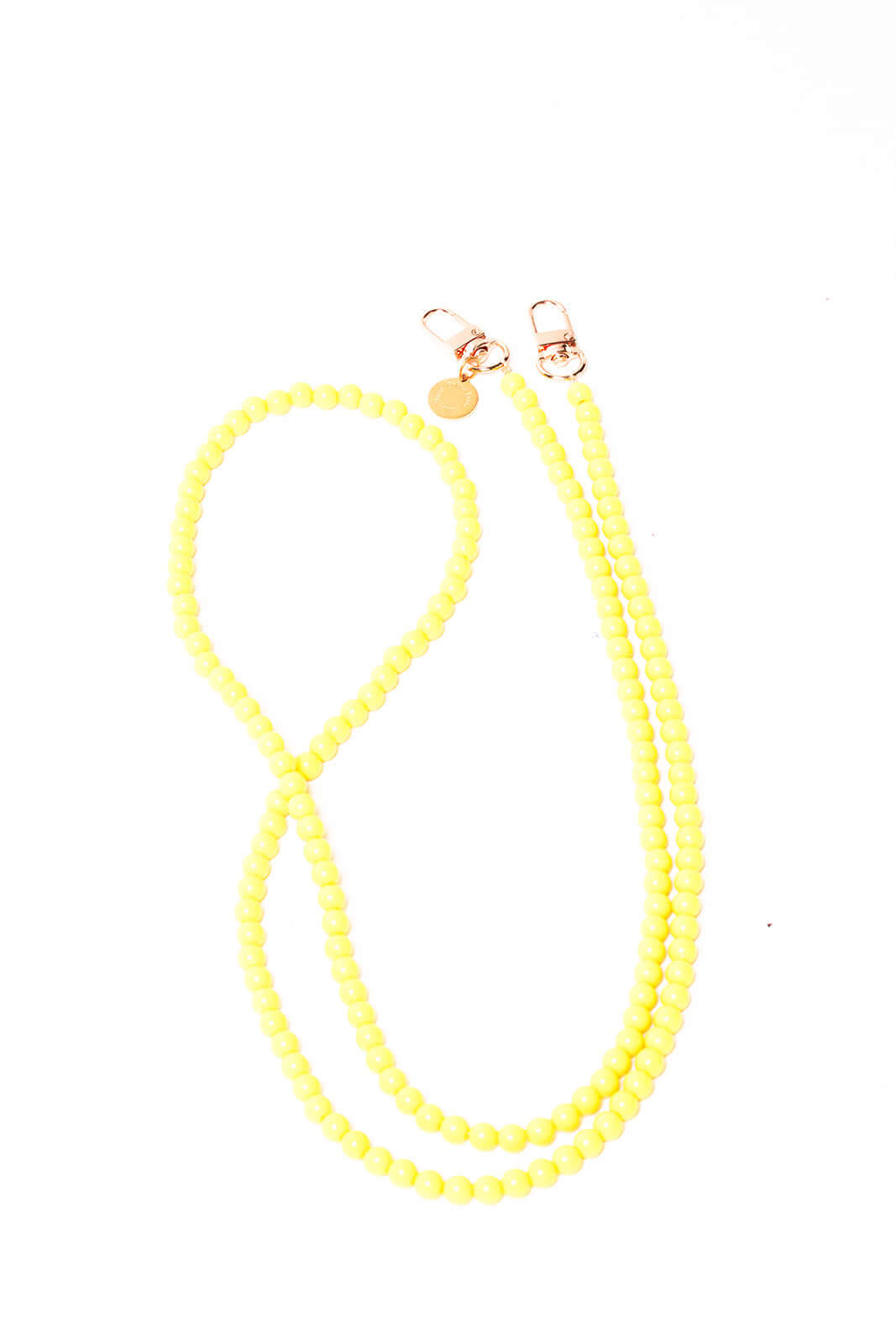 Pale yellow beaded Aurora PHONE CORD folded into loops with gold-tone clasps on a white background.