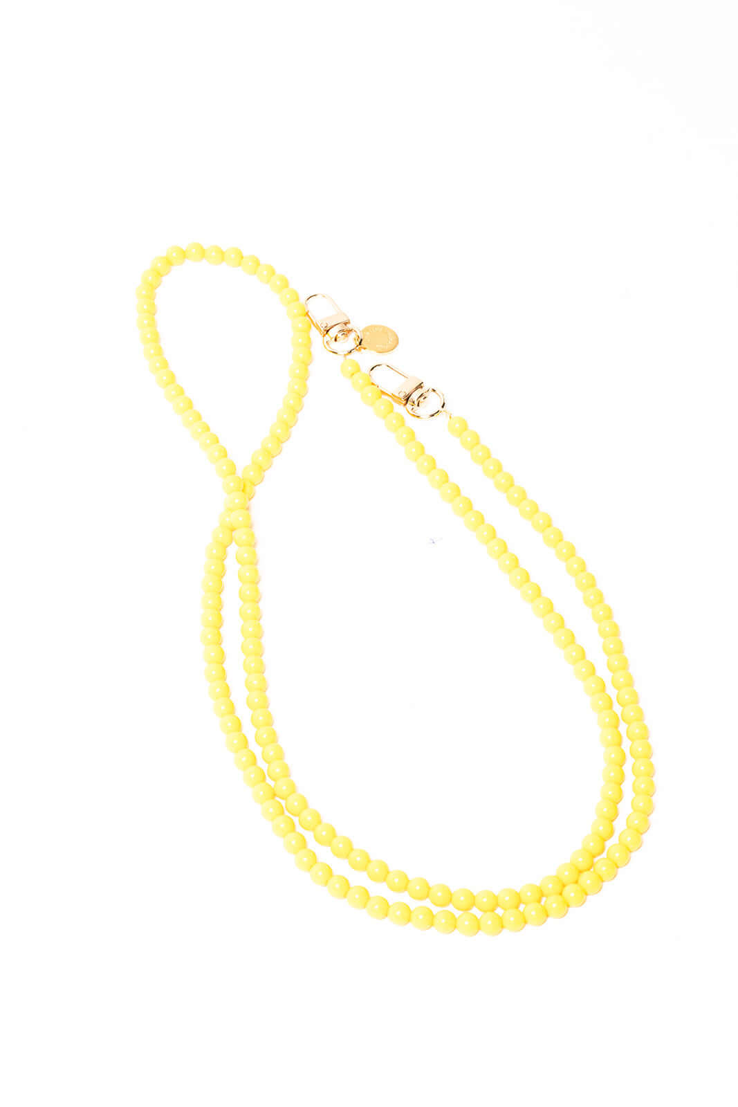 Pale yellow beaded Aurora PHONE CORD looped on a white background with gold-tone clasps.