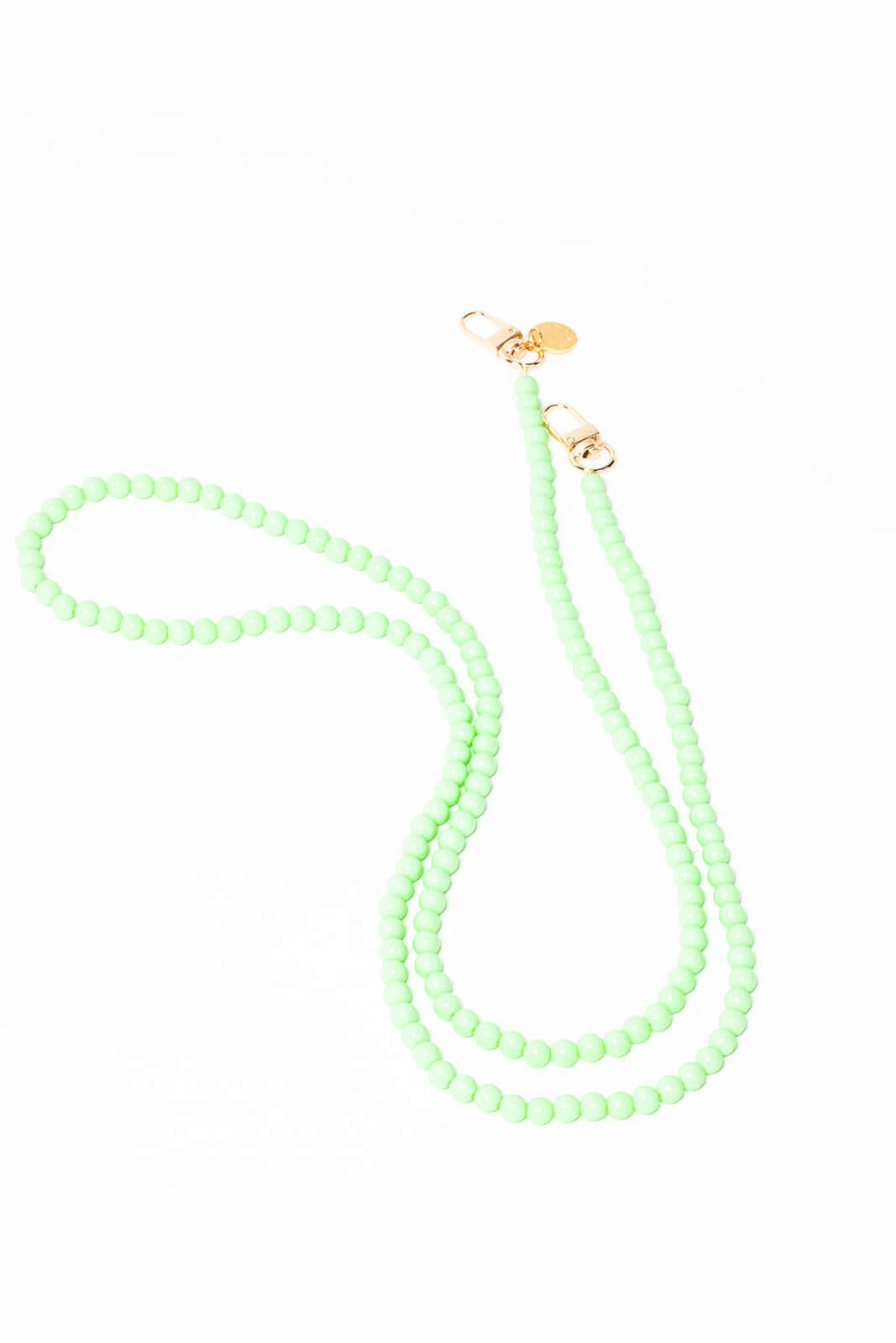 Mint green beaded Aurora PHONE CORD looped on a white background with gold-tone clasps.
