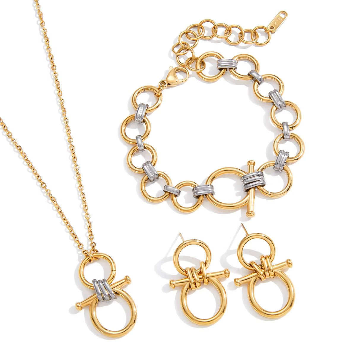 The Averi NECKLACE styled with a matching bracelet and stud earrings, all featuring gold circle links and silver ridged bars.