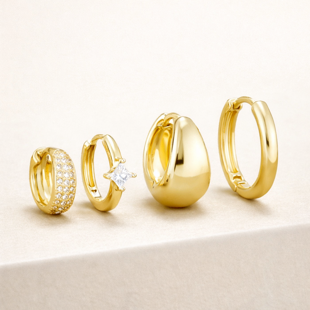 The Belle SET stacks four gold hoops: a pave huggie, a single-stone huggie, a chunky teardrop hoop, and a plain hoop.