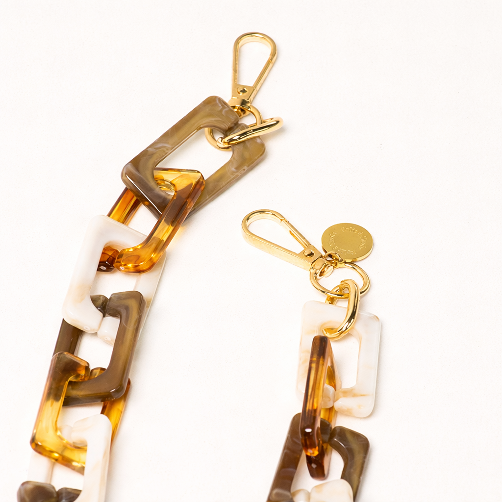Close-up detail of the amber tortoise and cream acrylic links on the Bennie phone chain.