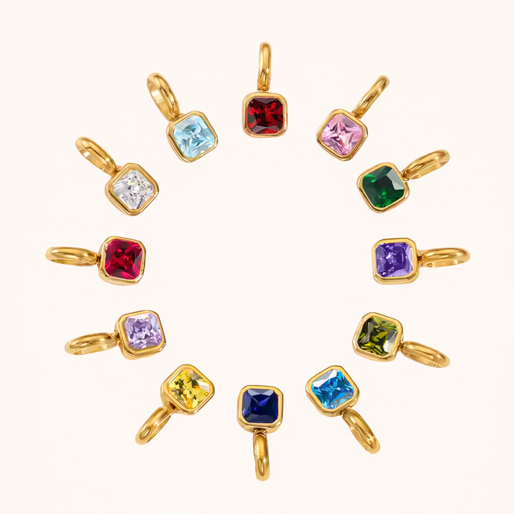 The Birthstone CHARM collection arranged in a circle, twelve square gemstone charms in gold settings representing every month.