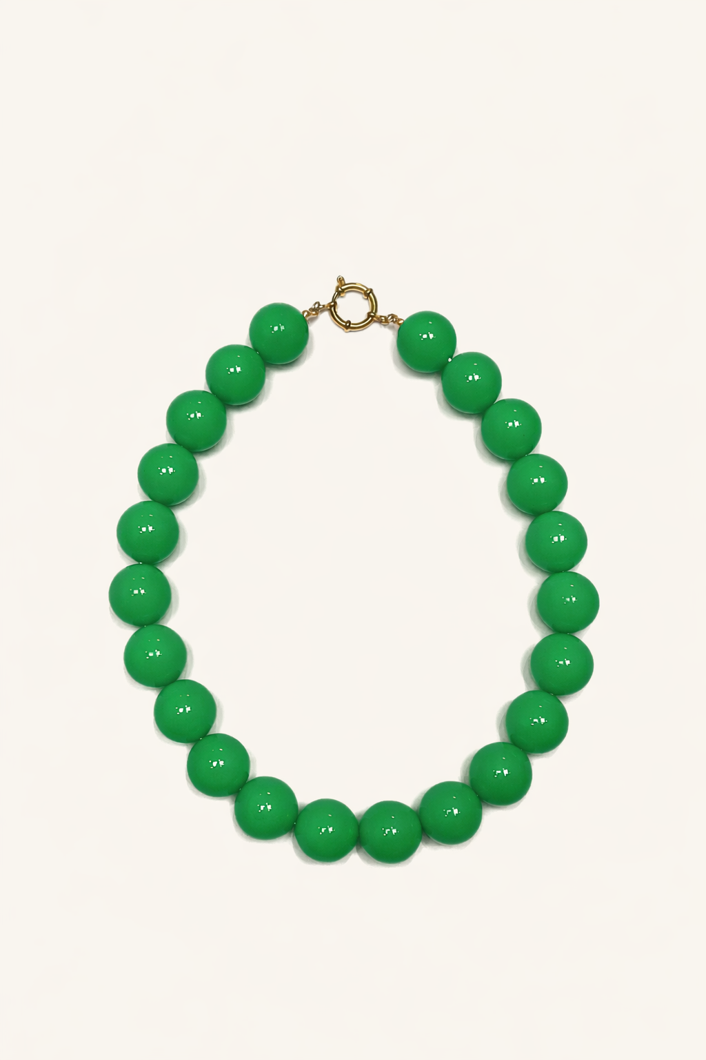 The Blaire NECKLACE in green, a single strand of large glossy round beads with a gold ring clasp, shown flat.