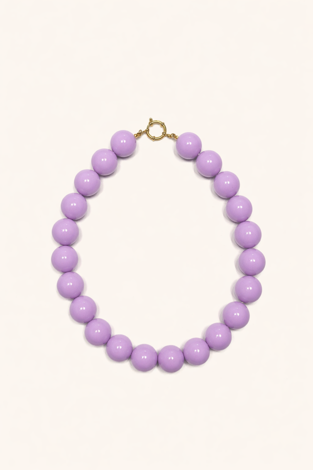 The Blaire NECKLACE in lilac, a single strand of large glossy round beads with a gold ring clasp, shown flat.