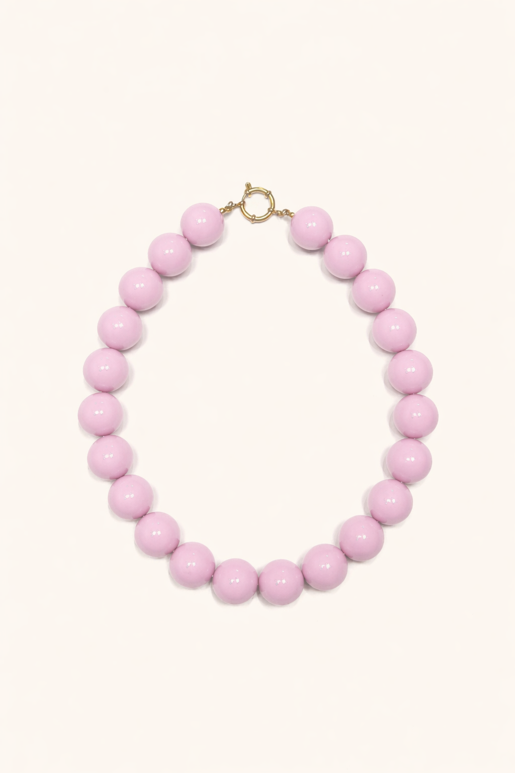 The Blaire NECKLACE in pale pink, a single strand of large glossy round beads with a gold ring clasp, shown flat.