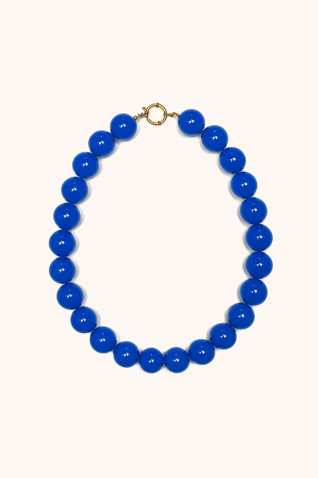 The Blaire NECKLACE in cobalt blue, a single strand of large glossy round beads with a gold ring clasp, shown flat.