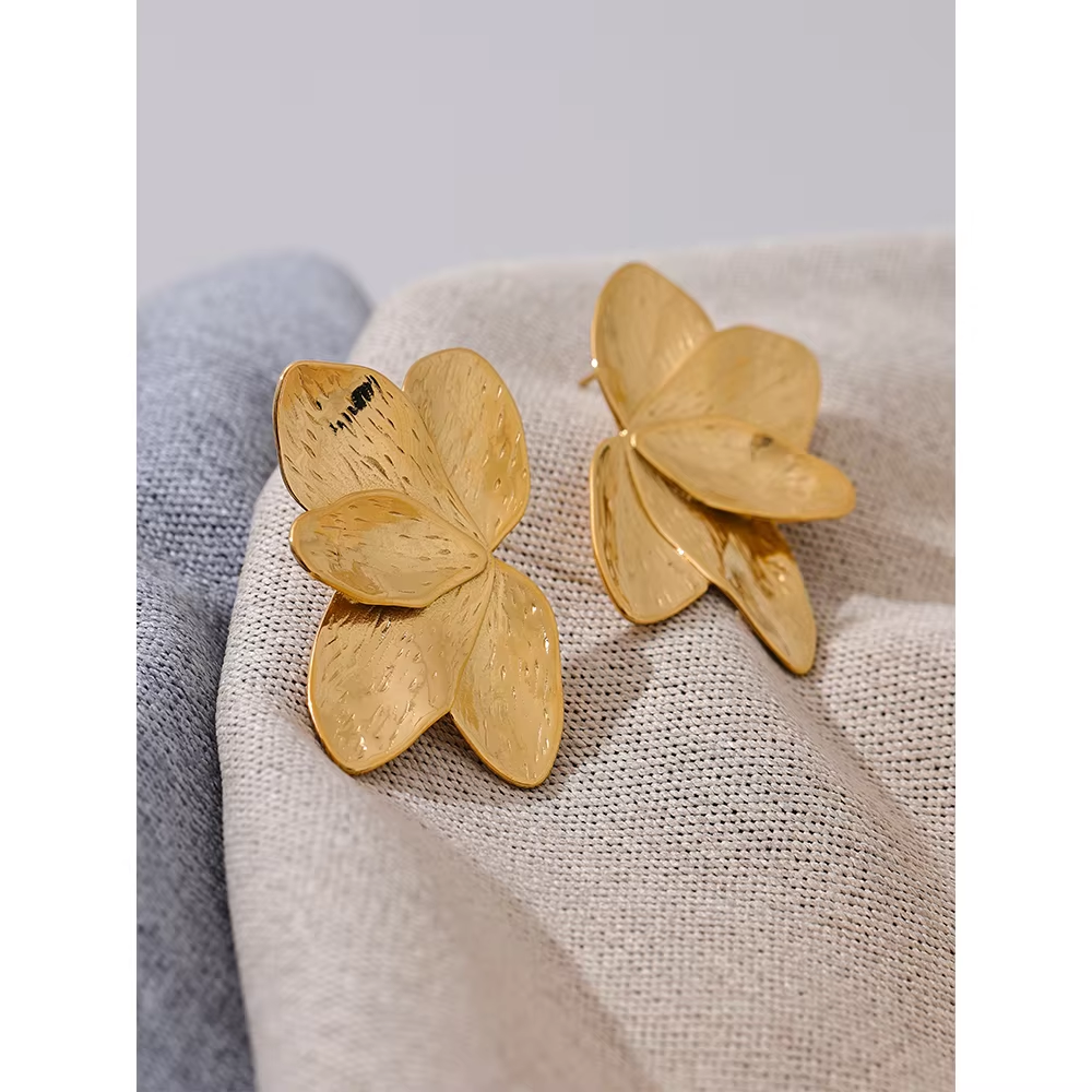 Bloom Earrings in gold on textured fabric, one shown face up and one turned to reveal the post back.
