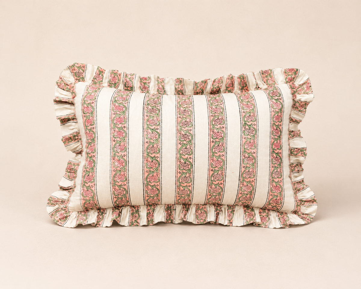 Blush Pink Rectangle cushion fabric lines a bread basket with fresh baguettes, its red scalloped edge visible against a pink table setting.