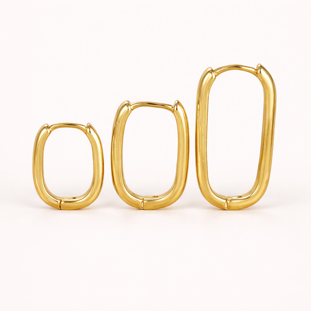 Bruna Set of gold rectangular oval hoops in three graduated sizes, shown standing side by side neatly.