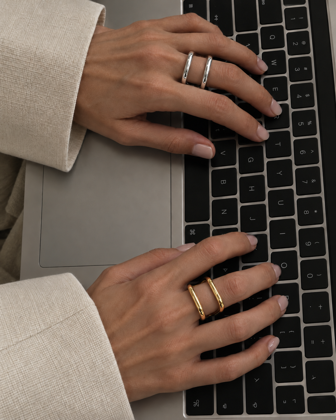 Hands typing on a laptop, one wearing the silver-tone Carré RING and the other the gold Carré RING — Folie à Trois wholesale