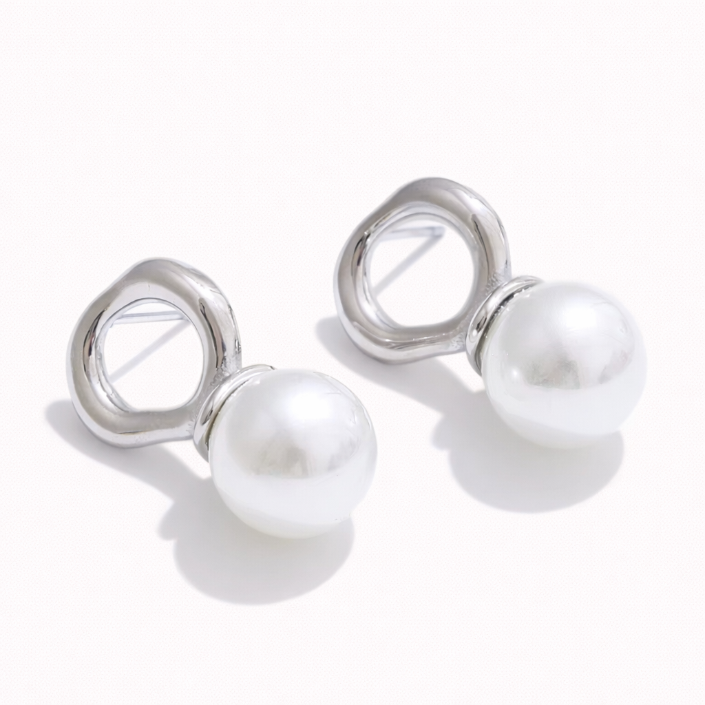 Cher Earrings in polished silver, an organic open-loop stud suspending a large lustrous pearl below.