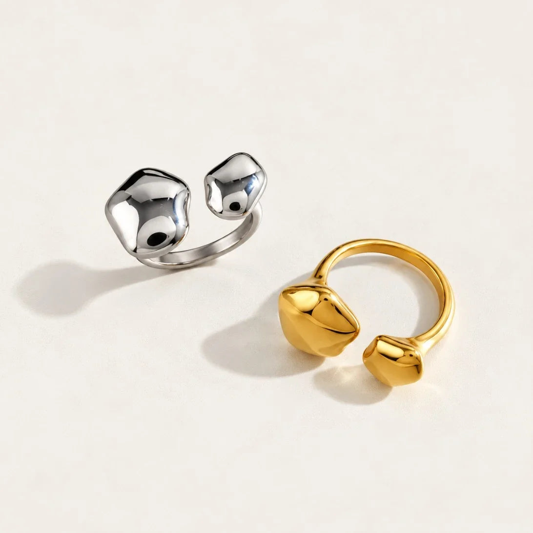 Silver-tone and gold Cloud RINGS side by side, open bands with sculptural pebble ends — Folie à Trois