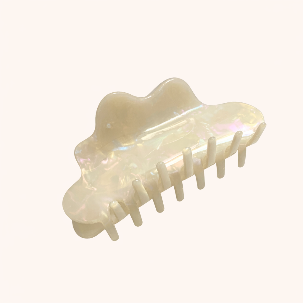 Cream iridescent acetate cloud-shaped claw clip from the Cloudy Day HAIR CLIP collection, on a cream background.