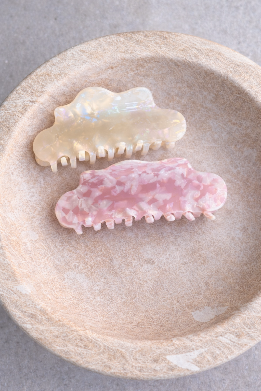 Cloudy Day HAIR CLIP's cream and pink cloud clips resting in a stone bowl.