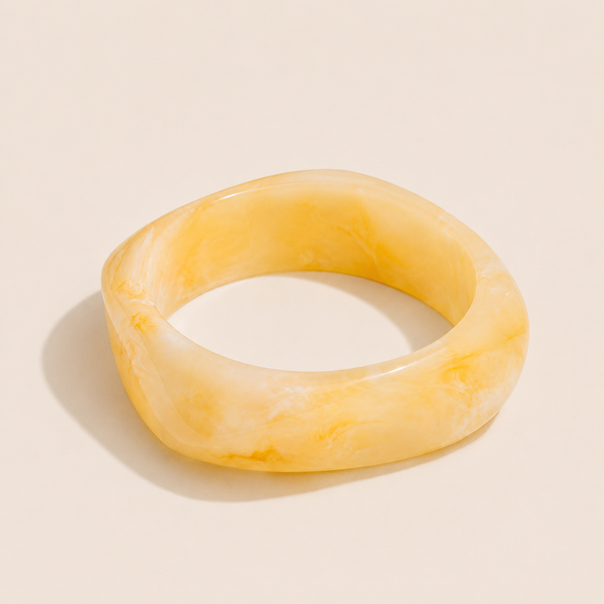 Coastal Escape BRACELET in yellow marbled resin, a chunky angular bangle shown alone on a cream background.