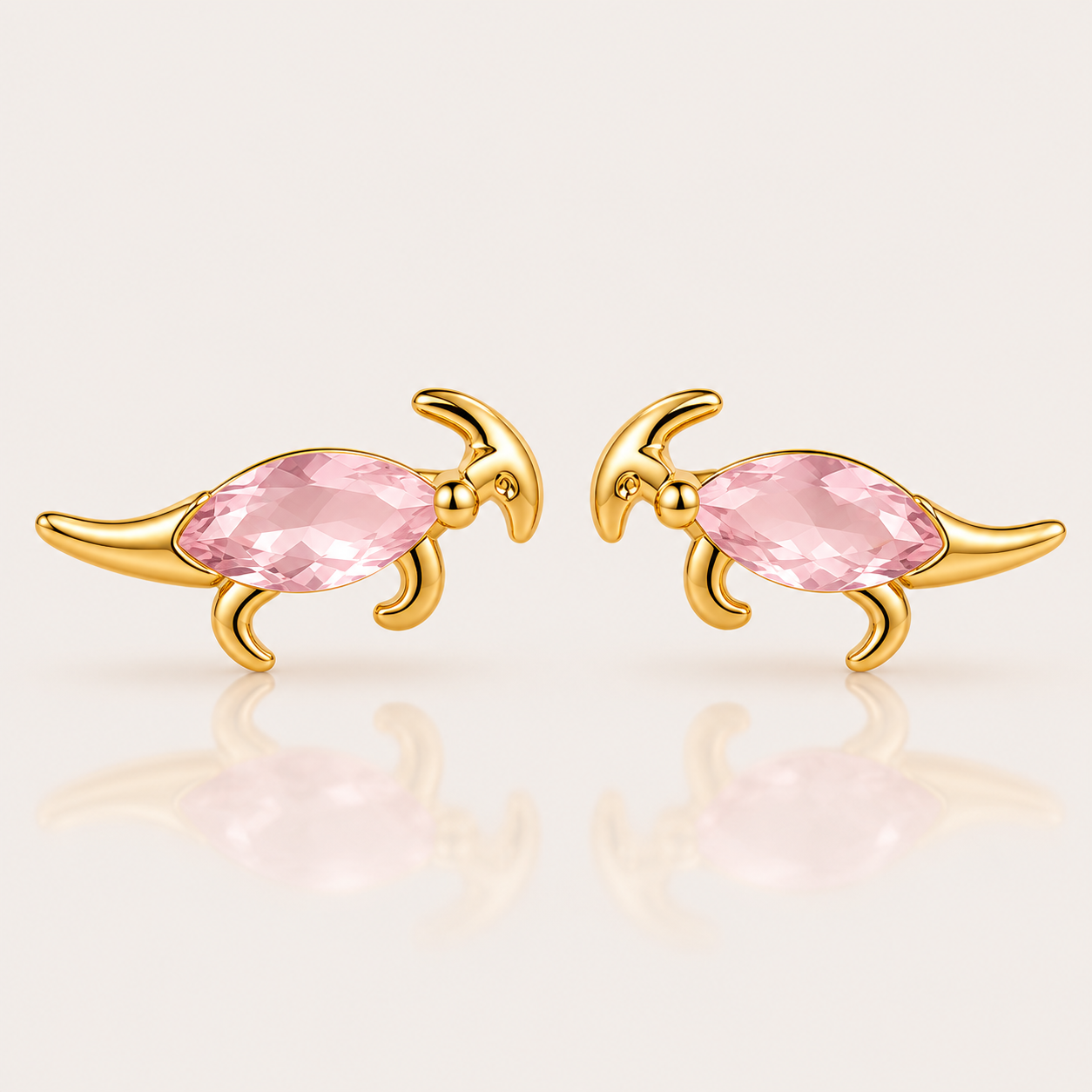 Gold parasaurolophus-shaped stud earrings from the Colorful Dino EARRINGS with a pink marquise cubic zirconia body.