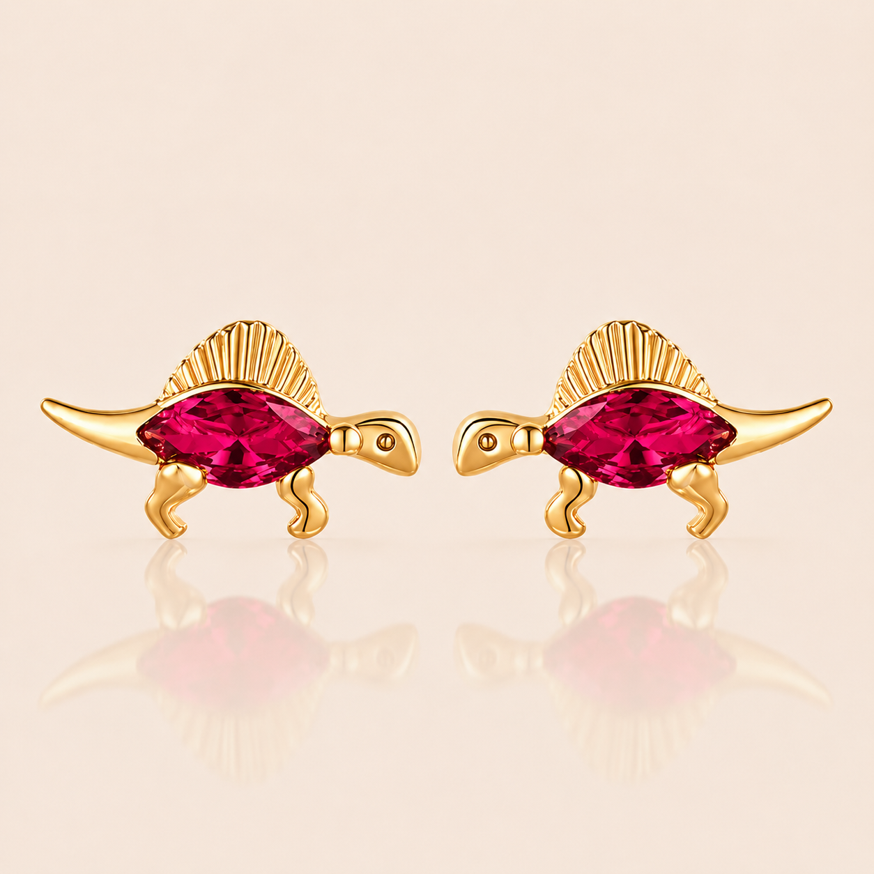 Gold spinosaurus-shaped stud earrings from the Colorful Dino EARRINGS with a fuchsia marquise cubic zirconia body and a ridged fan back.