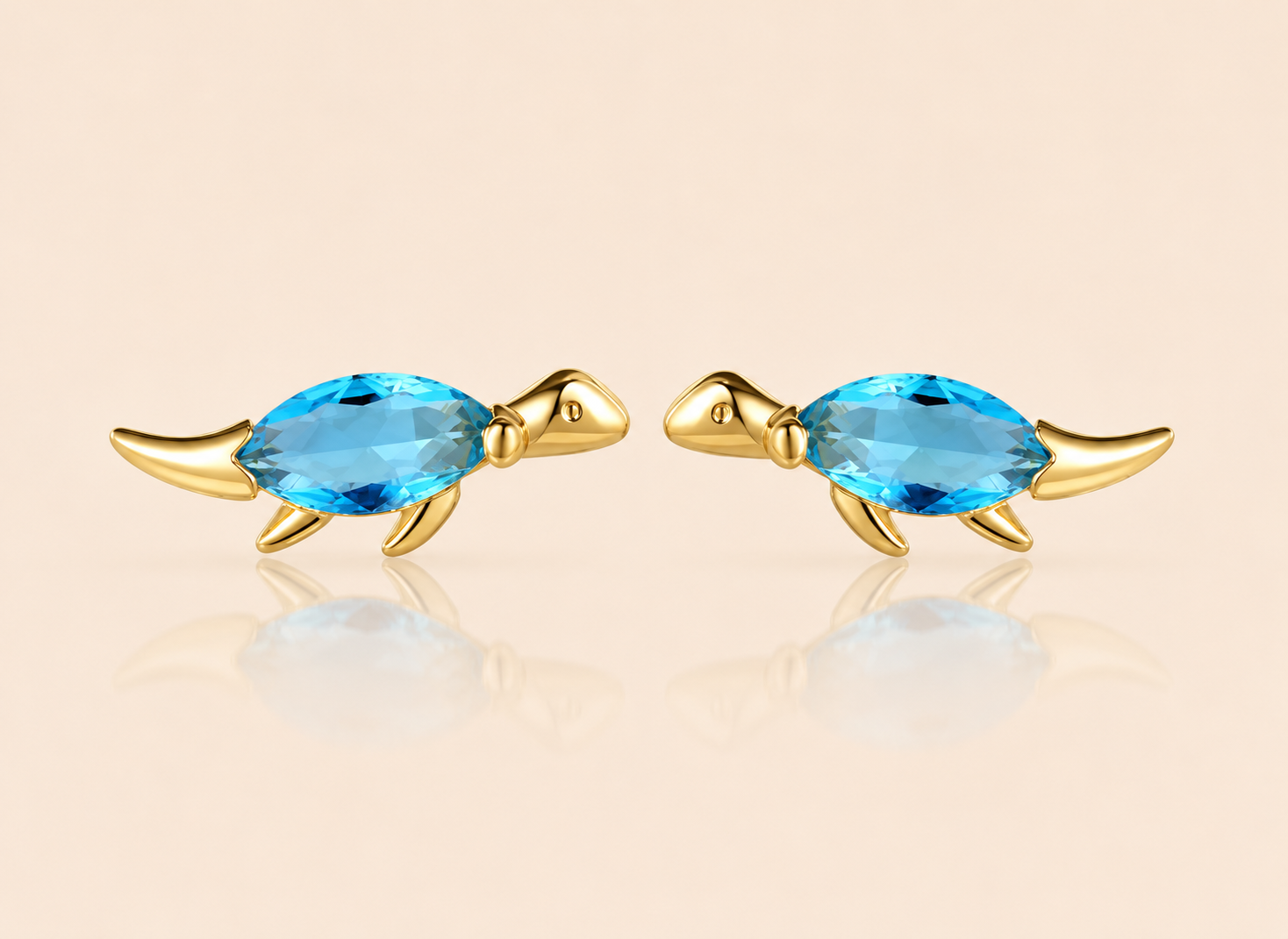 Gold dinosaur stud earrings from the Colorful Dino EARRINGS with a blue marquise cubic zirconia body in a walking pose with a long tail.
