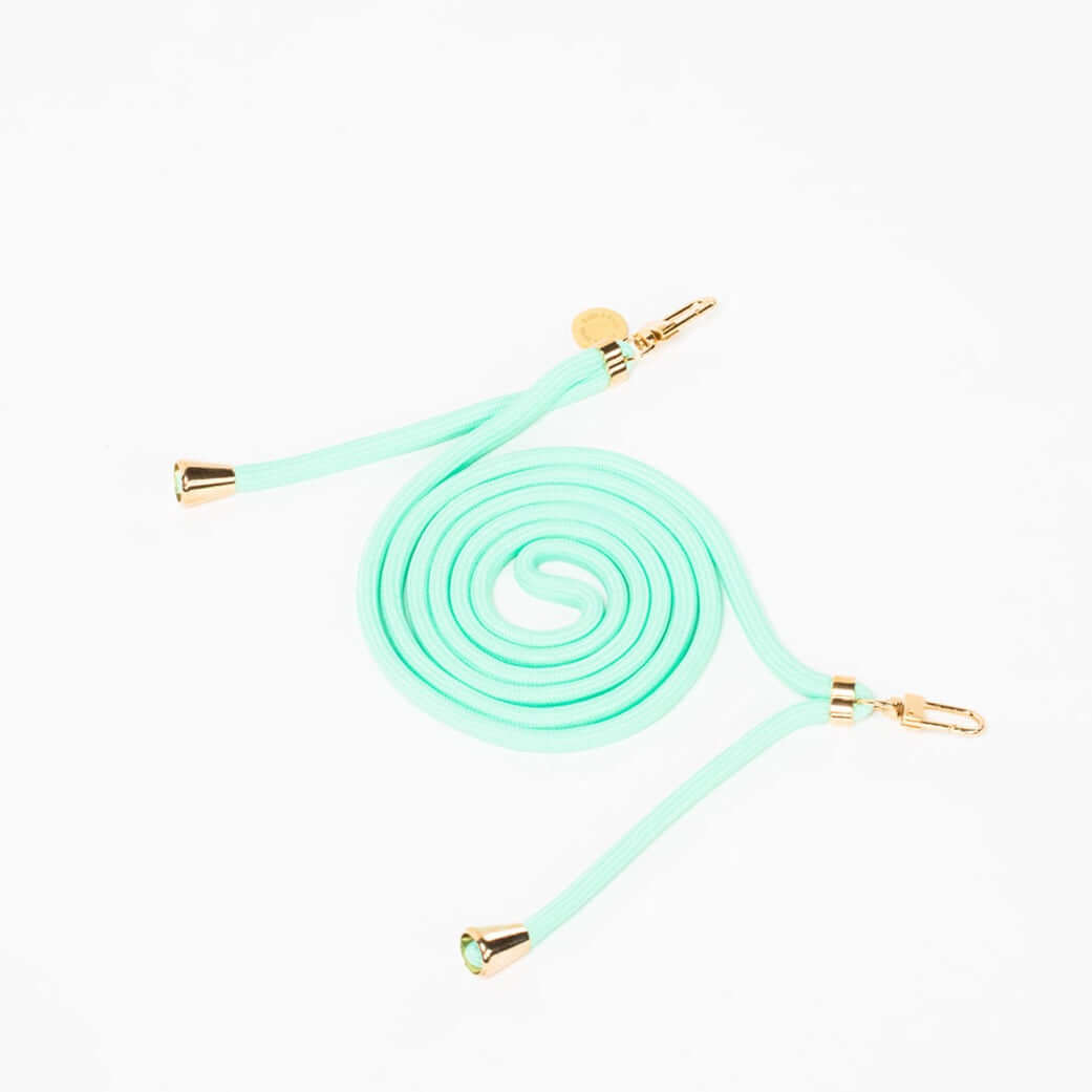 Mint green Colorful PHONE CORD coiled with gold-tone hardware, shown from another angle on white.