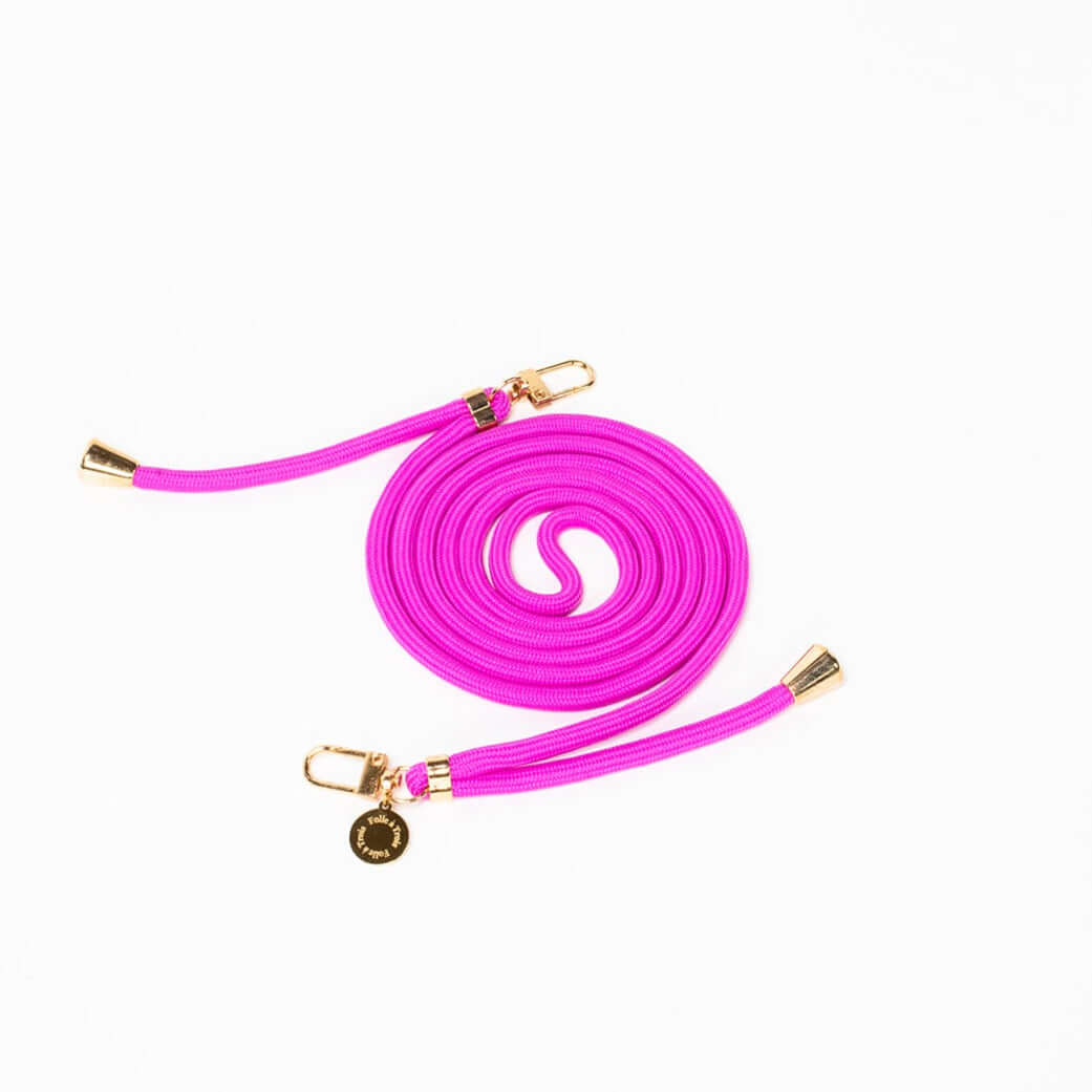 Magenta Colorful PHONE CORD coiled with gold-tone hardware on a white background.