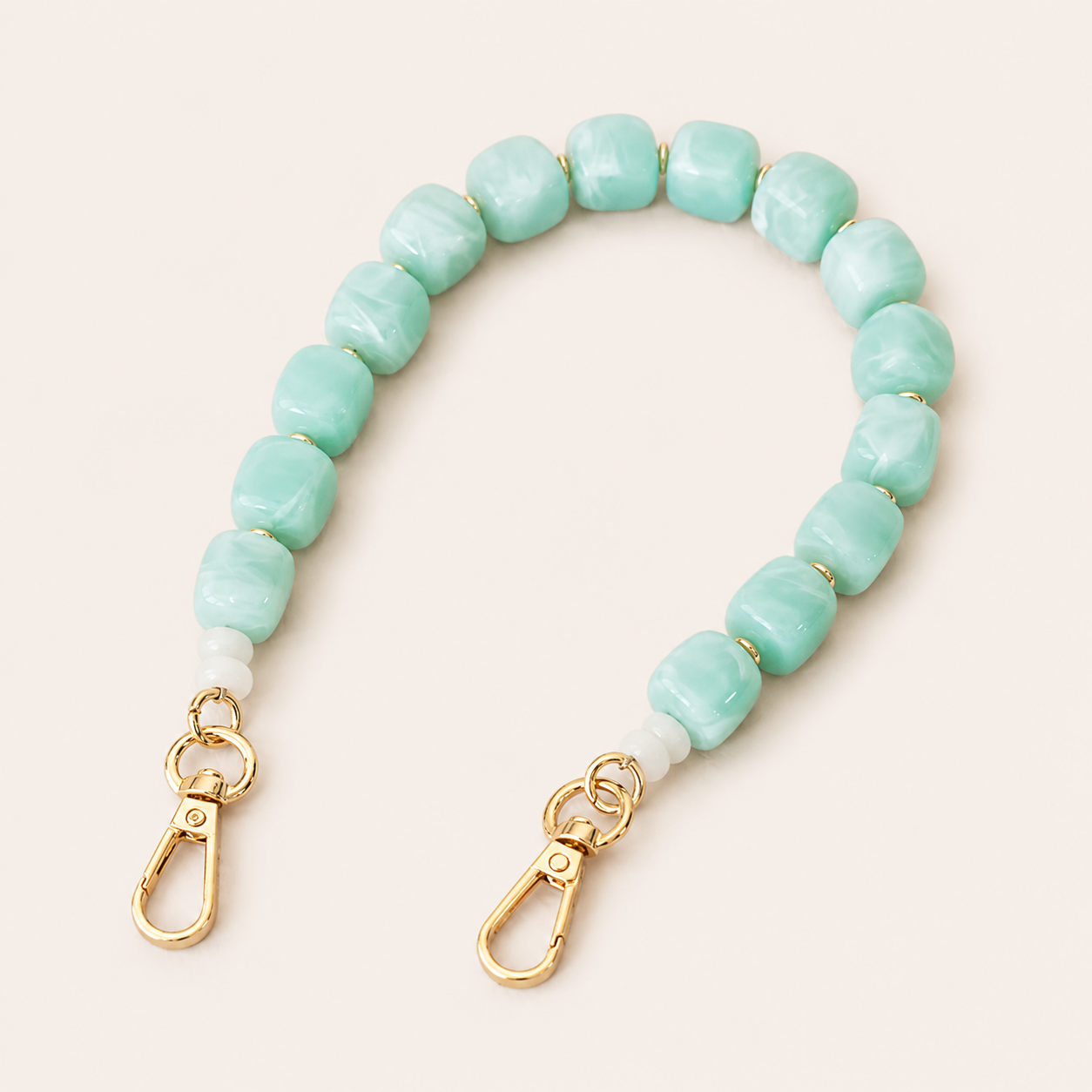 Mint green beaded phone chain with cube-shaped beads and gold clasps — Folie à Trois Cora wholesale phone accessory