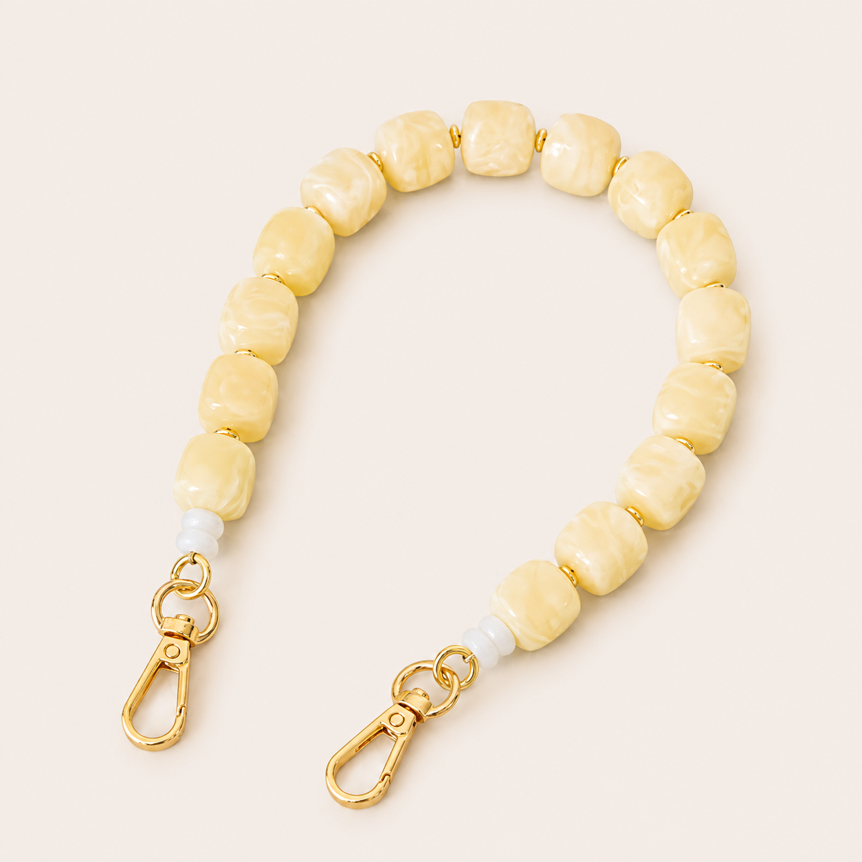 Cream yellow marbled beaded phone chain with cube beads and gold clasps — Folie à Trois Cora wholesale phone accessory