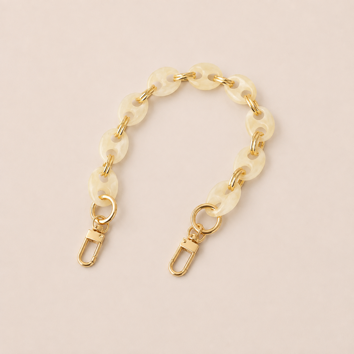 Round ivory marbled coin-link phone chain with gold connectors on cream — Folie à Trois Corvin short phone chain
