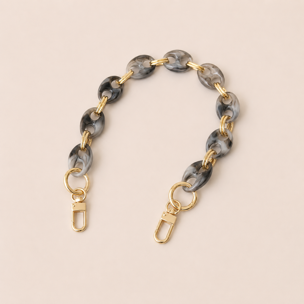 Round charcoal marbled coin-link phone chain with gold connectors on cream — Folie à Trois Corvin short phone chain