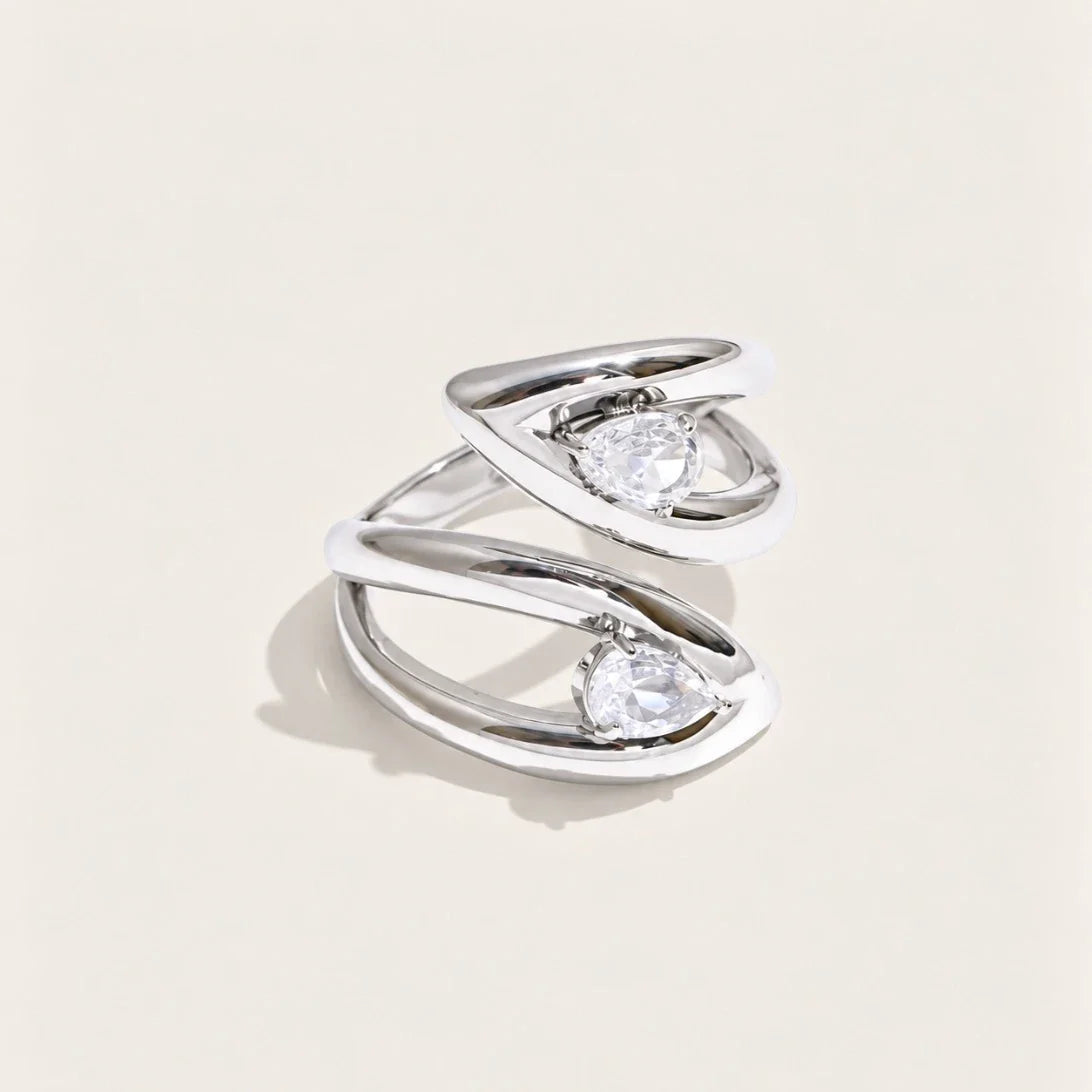 Silver-tone Croisé RING: two overlapping bands crossing around an oval white zirconia stone — Folie à Trois