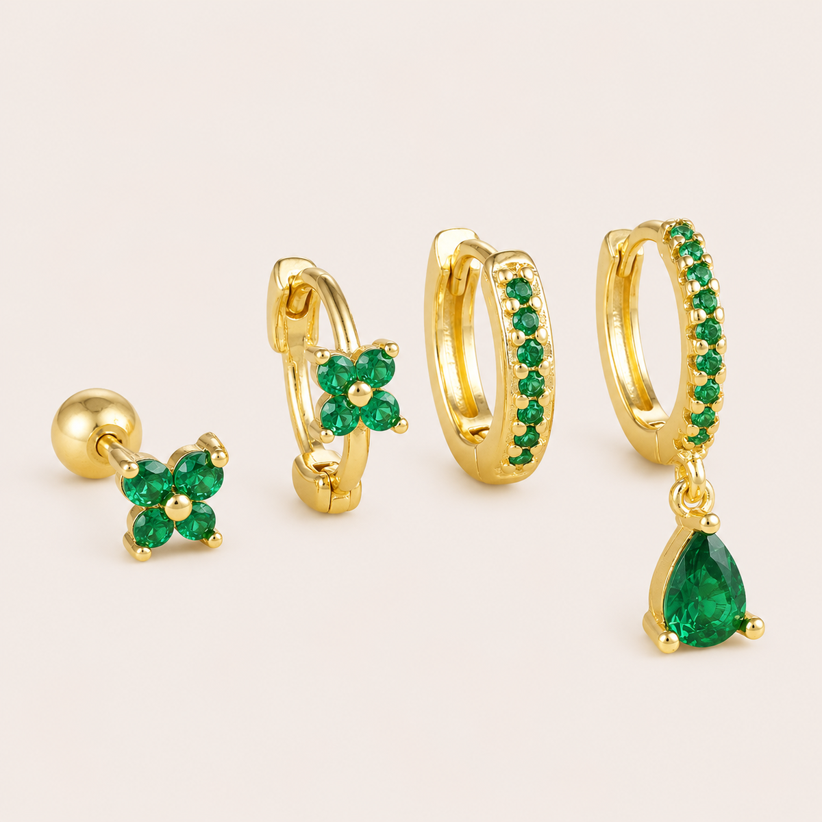 Four-piece Deanna SET gold earrings in green: a flower stud, a flower hoop, a pave hoop, and a pave hoop with a pear-cut drop charm.
