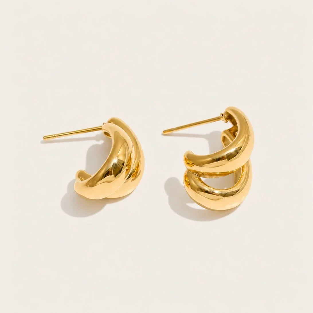 Gold Doppia EARRINGS: a pair of hoops formed by two smooth C-shaped curves layered together — Folie à Trois
