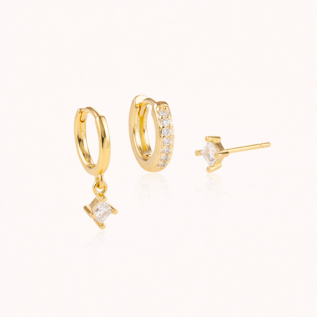 Eira Set gold huggie hoop with a dangling square crystal charm, a pave crystal hoop, and a square stud shown together.