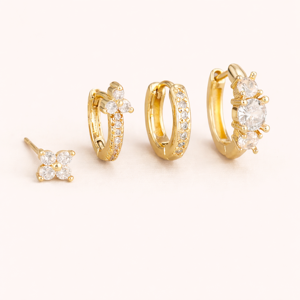 The Elle SET includes a clover stud, a flower-topped pave hoop, a plain pave hoop, and a cluster huggie.