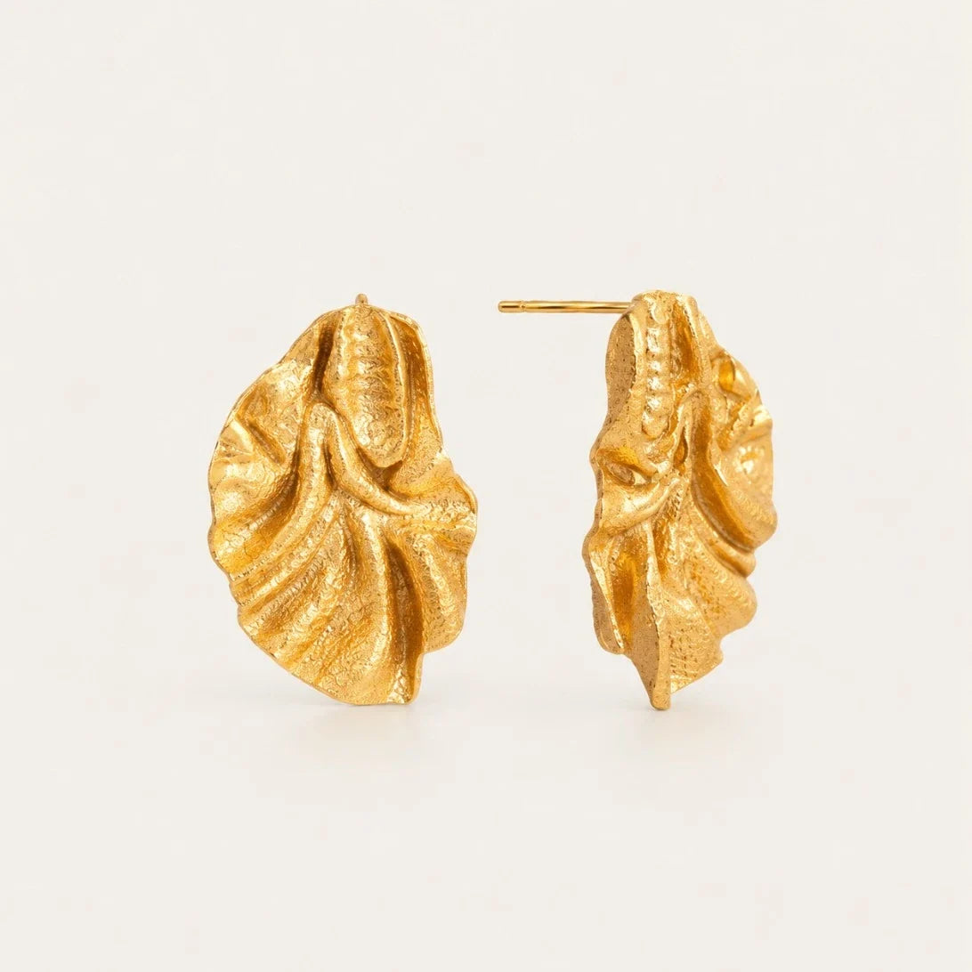 Gold Feuille EARRINGS: textured, ruffled leaf-shaped statement studs on a cream background — Folie à Trois